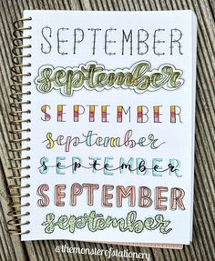 a spiral notebook with hand lettering on it and the words september written in cursive writing