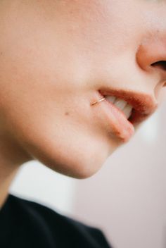 a close up of a person with a nose piercing on their left side of the face