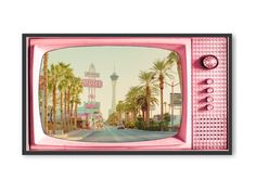 an old pink television with the las vegas sign in the background and palm trees around it