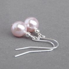 8mm rosaline Swarovski pearls have been used to create these simple blush pink dangle earrings. The simplicity of their design and the lustre of the pearls make these light pink dangly earrings perfect for everyday wear or for finishing off a special outfit. Each pale pink pearl earring drop dangles 15mm from the bottom of the ear hook. All metal elements used to create these baby pink mother of the bride earrings are Sterling silver. You will receive your earrings with a complimentary pair of plastic stoppers to ensure they stay securely in place. Your powder pink jewellery will arrive gift wrapped and ready to present as a gift or enjoy as a treat to yourself. All of my parcels are packaged with care to ensure their safe arrival. --------------------- Matching items available ----------- Classic Pink Pearl Drop Earrings, Classic Pink Dangle Earrings, Classic Pink Pearl Drop Jewelry, Classic Pink Dangle Jewelry, Pink Pearl Bridal Earrings As Gift, Pink Pearl Bridal Earrings For Gift, Classic Pink Pearl Earrings As A Gift, Classic Pink Pearl Earrings For Wedding, Classic Pink Earrings For Wedding