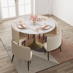 a dining table with four chairs around it