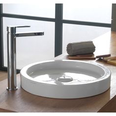 a white sink sitting on top of a wooden counter