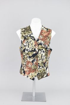 Lovely all over floral pattern fitted vest in black, olive green and a mauve pink-coral tones. Small brown colored buttons down the front. Lightweight blend of textured linen and cotton. The inside is lined in silky black fabric for comfort.  Brand Rafaella // 90s era Condition Great condition No rips, tears or stains Lightly steam cleaned for freshness Dry clean only Smoke free home Size Women's Medium Measurements Shoulder to shoulder - 13" Arm opening - 10" Bust - 36 - 38" Waist - 35" Hips - 36" Length front - 23" Length back - 21" Materials  55% Linen, 45% Cotton ♡ Tid Bit More Info ♡ Please check measurements carefully, vintage sizing can vary from modern day sizing. Measurements are taken on the outside of the garment while lying flat and then doubled. If the garment is stretchy the 90s Jean Dress, Waistcoat Top, Linen Waistcoat, 90s Vest, Fitted Vest, Floral Vest, Winter Knitwear, Floral Vests, 90s Era