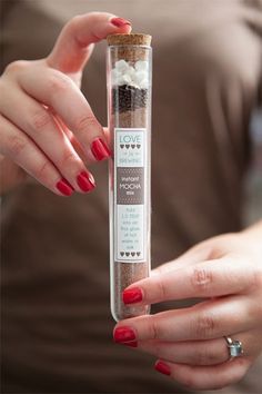 a woman holding a tube filled with spices