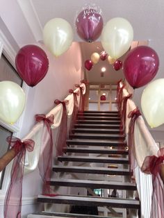 the staircase is decorated with red and white balloons