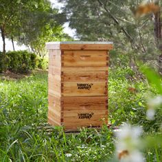 a beehive sitting in the middle of some grass