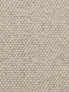 an up close shot of the texture of a beige carpet with white and gray colors