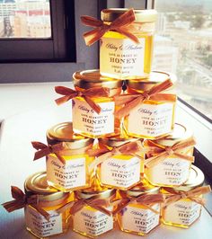 a stack of honey jars sitting on top of a table