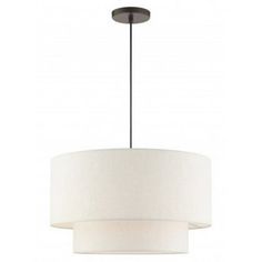 a light fixture with a white drum shade on the bottom and a black metal base