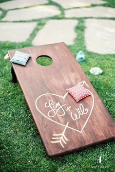 a cornhole board with a heart and arrow on it that says, we're married