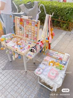 a table with many items on it and people looking at them from the other side