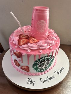 a pink starbucks cake with strawberries on top