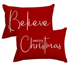 two red pillows with the words believe merry christmas written on them, both in white ink