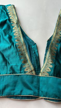 3/4 sleeves on a beautiful teal Valkalam material blouse with a little of silver and gold hint. Thick silk with lining and front open.color is super bright and can be paired with any black,red,gold,silver saree or any other color your heart desires. Luxury Silk Thread Unstitched Blouse Piece, Festive Straight Kurta Tops For Party, Festive Silk Tunic Blouse, V-neck Kurta With Pallu For Festivals, Gold V-neck Sets For Festive Occasions, Gold V-neck Festive Sets, Unstitched Straight Kurta Blouse Piece, Festivals V-neck Kurta With Pallu, Festival V-neck Kurta With Pallu