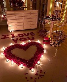 valentine's day decoration with candles and roses in the shape of a love heart