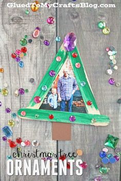 the christmas tree ornament is made out of colored paper and has a photo on it