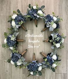 a wreath made out of blue and white flowers on a wooden floor with corks