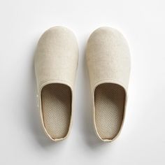 a pair of slippers sitting on top of a white floor