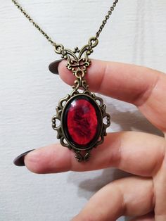 ◆ Victorian style necklace. The red blood cabochon size is 0.984252 x 0.708661 inches and it was completely handmade in resin. The inserts, the base and the chain are in bronze, The product is made by hand with great care. ♡ In my shop there are many handmade jewelry for all tastes, come and watch them are welcome! ♡ Blood Jewelry, Red Stone Pendant, Red Stone Necklace, Goth Things, Witch Necklace, Blood Stone, Victorian Necklace, Victorian Pendants, Red Pendants