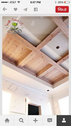 an unfinished ceiling with wooden beams and white walls