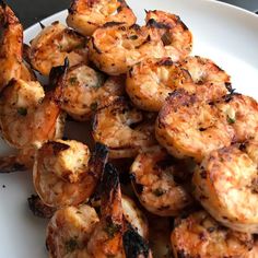 grilled shrimp is served on a white plate