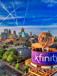 an aerial view of the city skyline with a giant xfinity sign on top