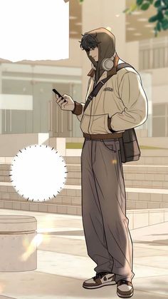 a man wearing headphones is looking at his cell phone while standing on the sidewalk