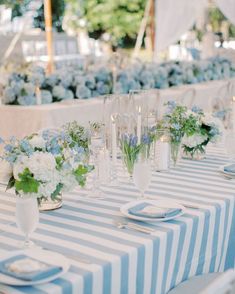 the table is set with blue and white flowers