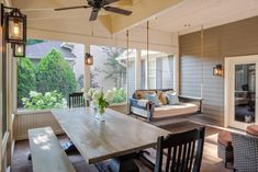 an outdoor living room with wood flooring and wooden furniture on the outside patio area