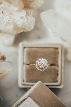 an engagement ring sitting on top of a box