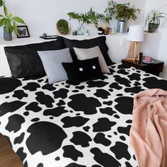 a black and white cow print bed spread