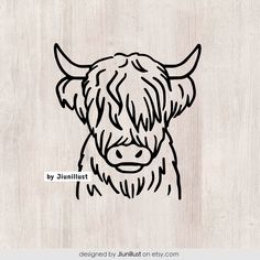 a drawing of a cow's head on a wooden background with the words by juliat