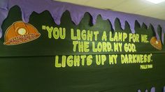 a bulletin board with words written on it in front of purple and green paint drips