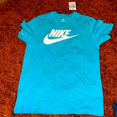 Men’s Nike Shirt New With Tags Light Blue Logo Print Crew Neck T-shirt, Light Blue Crew Neck T-shirt With Logo, Casual Light Blue T-shirt With Logo Print, Casual Light Blue T-shirt With Logo, Blue Short Sleeve Shirt With Branding, Blue Branded Crew Neck Top, Blue Graphic Tee With Branding, Blue Crew Neck Top With Branding, Nike Blue Crew Neck T-shirt