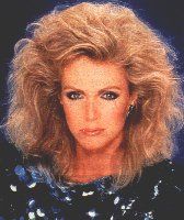 an old photo of a woman with blonde hair and blue eyes wearing a sequin top