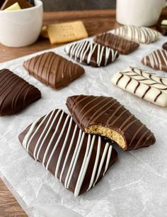 chocolate covered cookies are lined up on a table