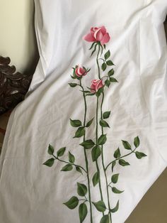 a white sheet with pink roses on it