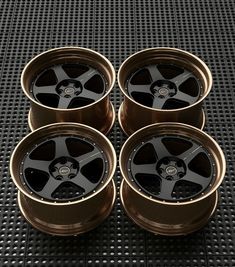 four black wheels are shown on a metal surface