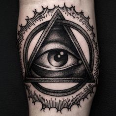 an all seeing eye tattoo on the leg