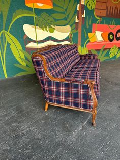 a couch sitting in front of a colorful wall