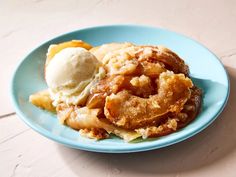 a blue plate topped with apple pie and ice cream