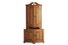 a tall wooden cabinet sitting next to a white wall