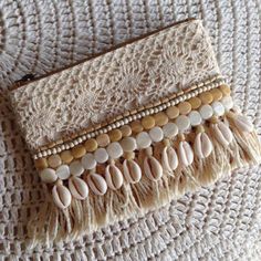 a purse with shells and beads on it