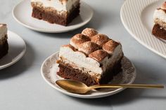 three slices of cake on plates with gold spoons