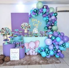 an elephant themed birthday party with balloons and decorations on the floor, including blue, purple, and green colors