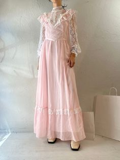 "- Vintage 1970s pink Gunne Sax peasant dress - Long sleeves and high neckline - The size and fabric content tags have been removed  - Zipper and buttons up the back - Small - Medium Bust: 17\" Waist: 14\" Length: 56.5\"" Pink Long Sleeve Peasant Dress, Cottagecore Pink Vintage Dress With Ruffles, Pink Cottagecore Vintage Dress With Ruffles, Vintage Pink Prairie Dress For Summer, Fitted Pink Vintage Cottagecore Dress, Pink Vintage Dress With Ruffles For Daywear, Pink Fitted Cottagecore Vintage Dress, Pink Prairie Dress For Spring Daywear, Pink Prairie Dress For Daywear In Spring