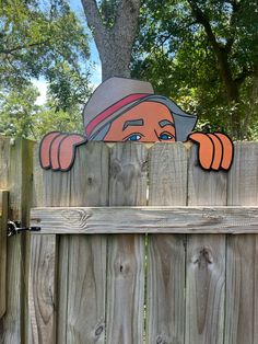 a wooden fence with a cartoon character on it