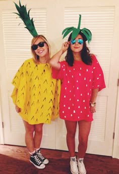 two girls wearing pineapple costumes standing next to each other in front of a door