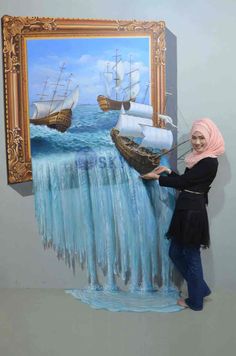 a woman standing in front of a painting that looks like water falls from the ocean