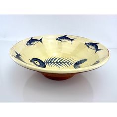 a blue and white bowl with fish on it